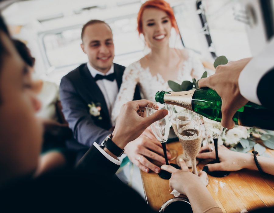 stylish-happy-bride-and-groom-toasting-with-glasses-of-champagne-and-having-fun.jpg